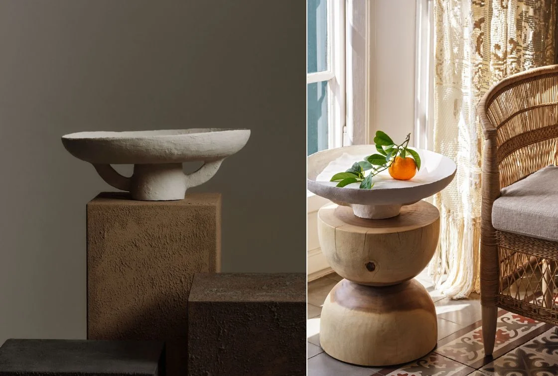 Mesa auxiliar con decoración de frutas y silla de mimbre
